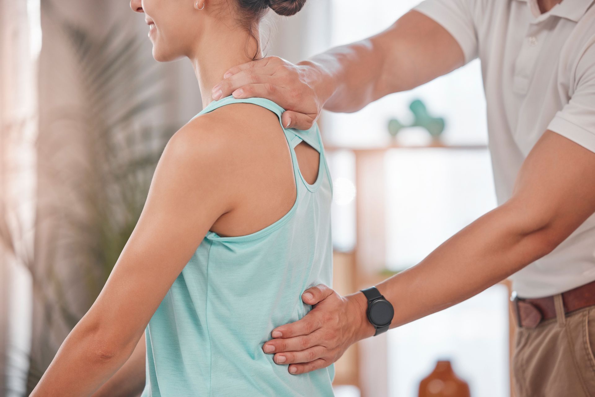 A man is giving a woman a massage on her back.