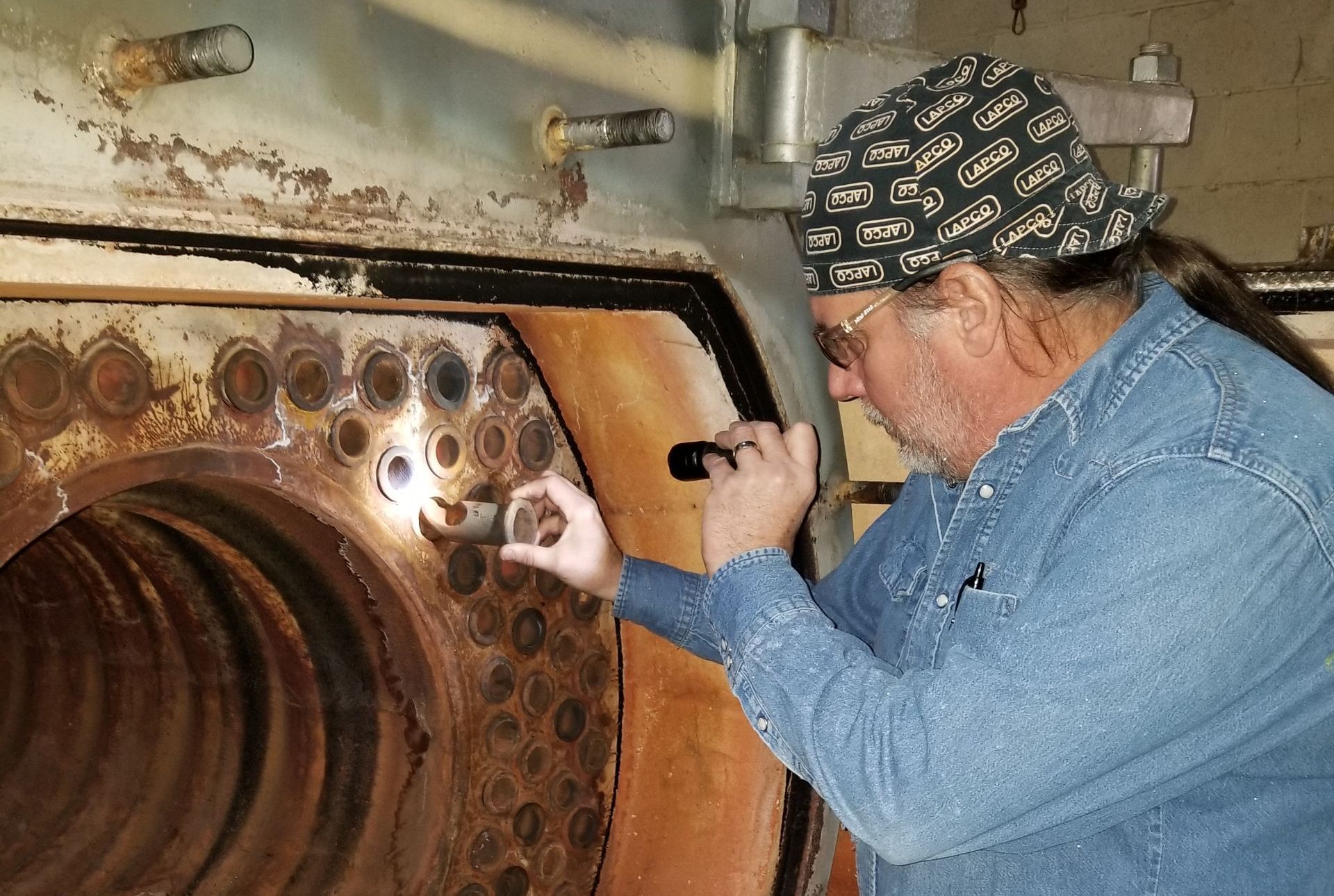 man inspecting boilers