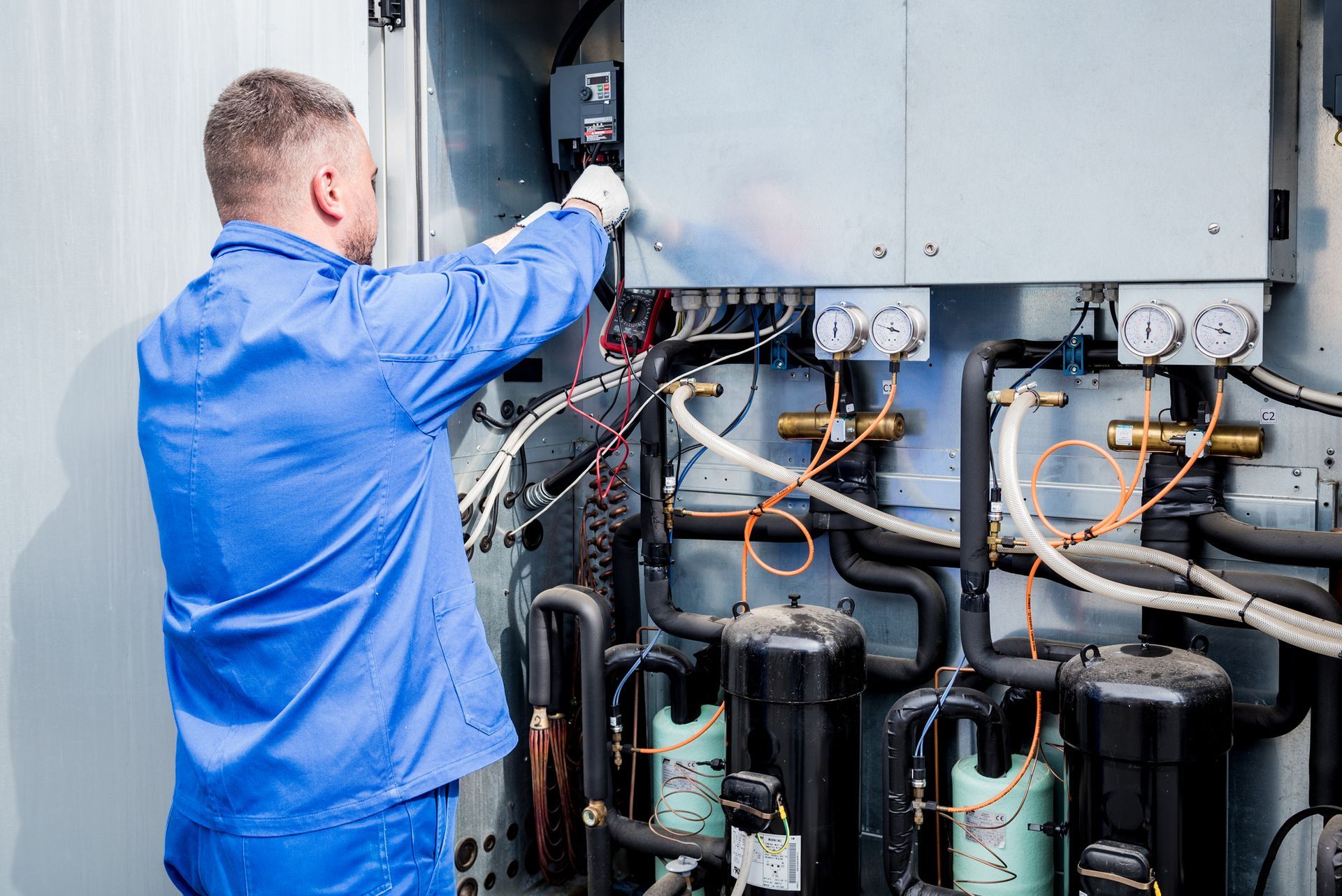 man inspecting boilers
