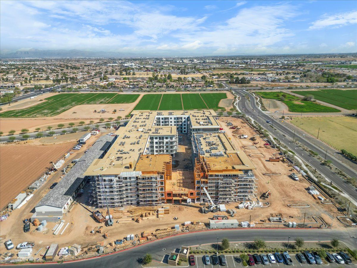 An aerial view of a large building under construction in a city.