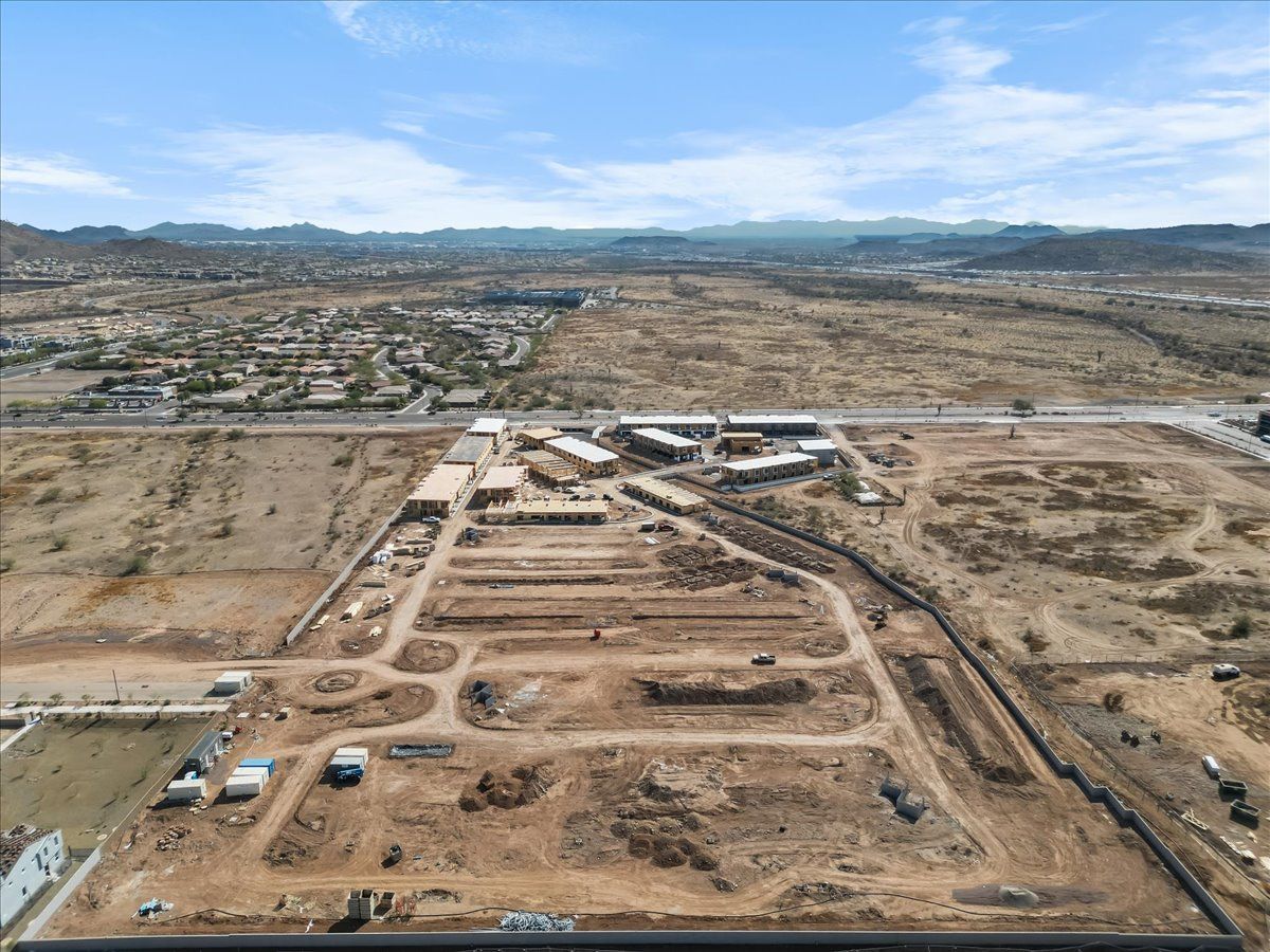 An aerial view of a desert landscape with a lot of dirt and buildings.
