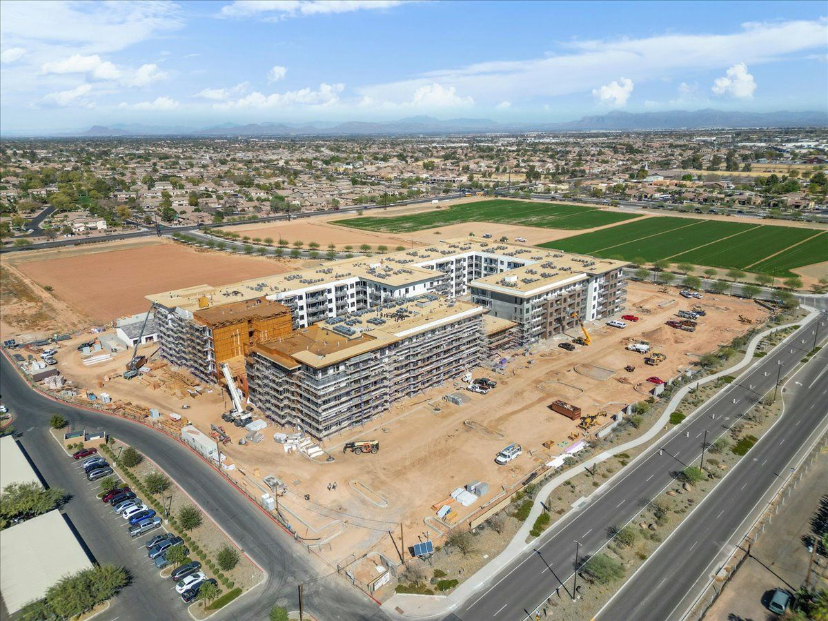 An aerial view of a large building under construction in a city.