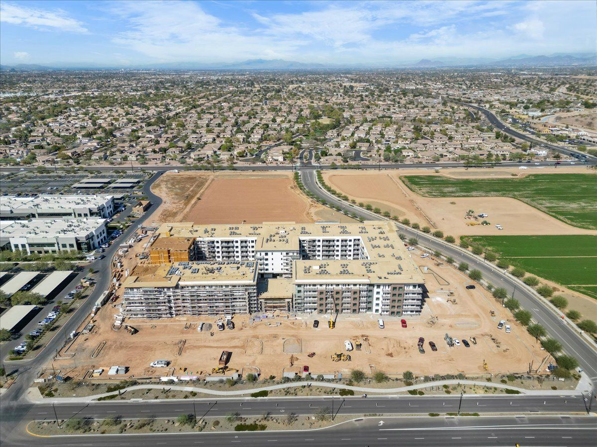 An aerial view of a large building under construction in a city.