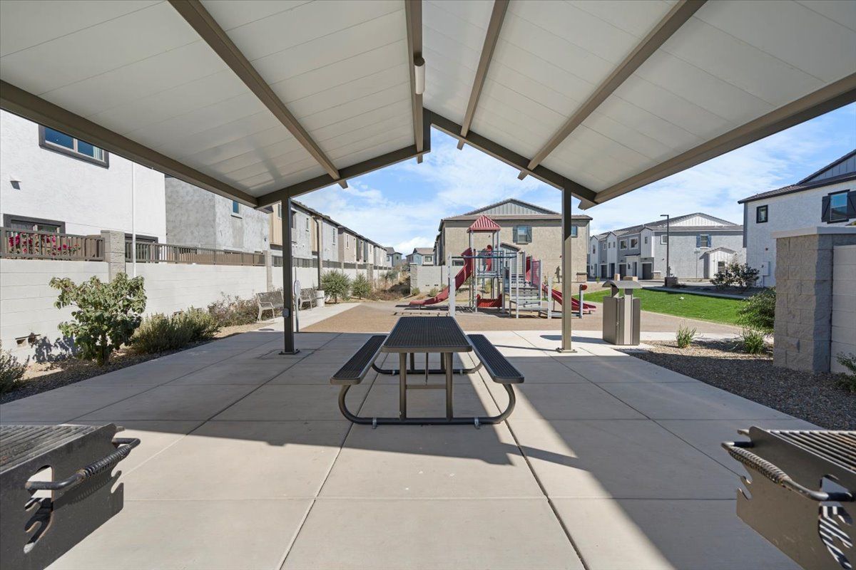 A picnic table under a canopy in a park