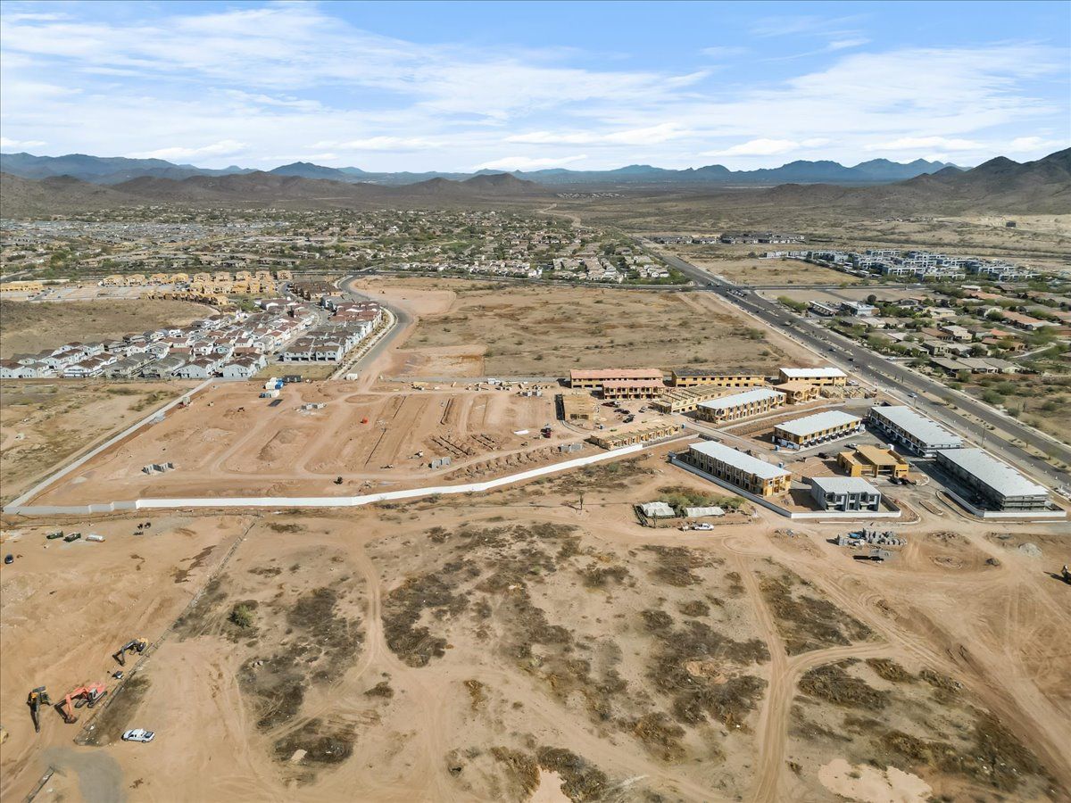 An aerial view of a desert landscape with mountains in the background.