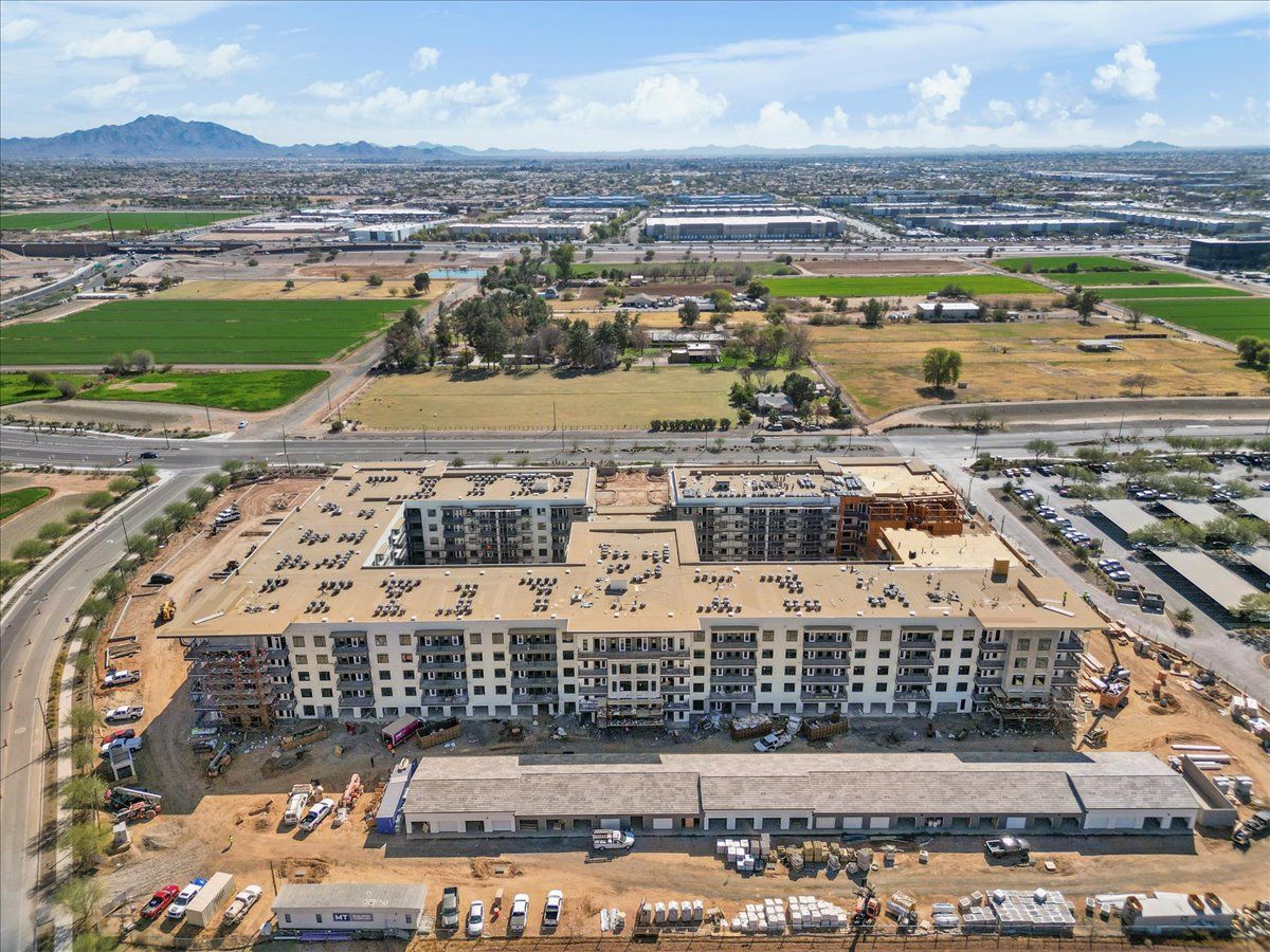 An aerial view of a large building under construction in a city.