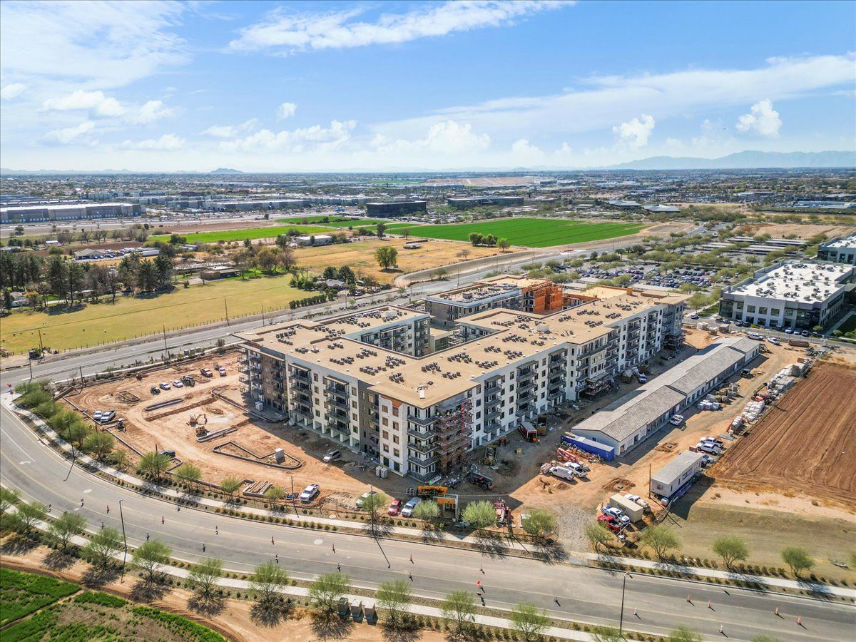An aerial view of a large apartment building under construction in a city.