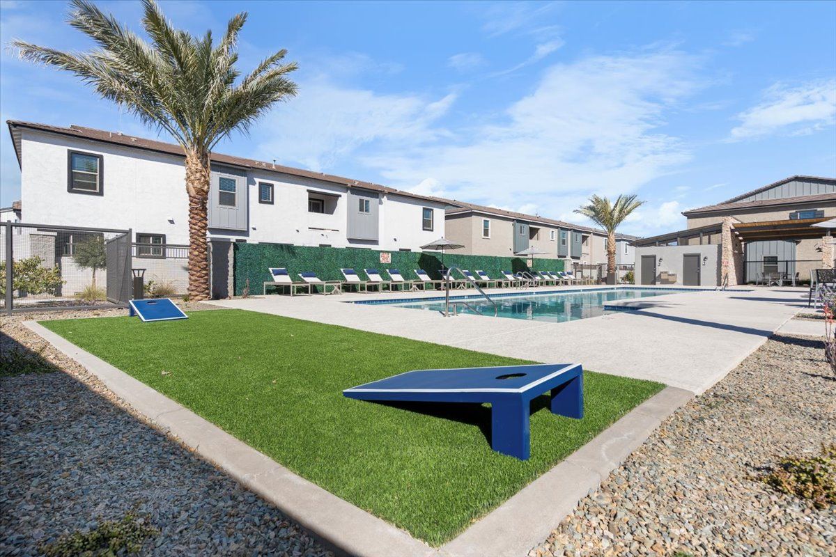 A bowling alley in front of a building with a pool.