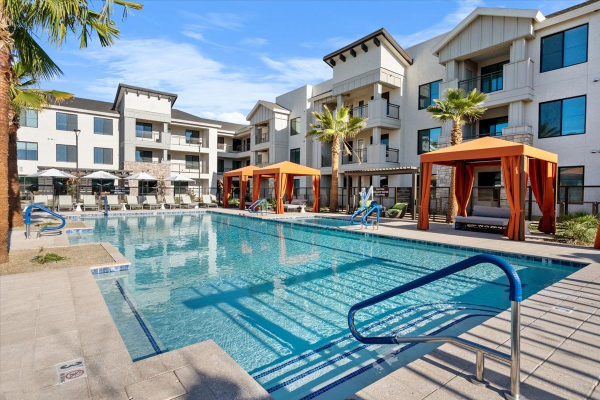There is a large swimming pool in the middle of a building.