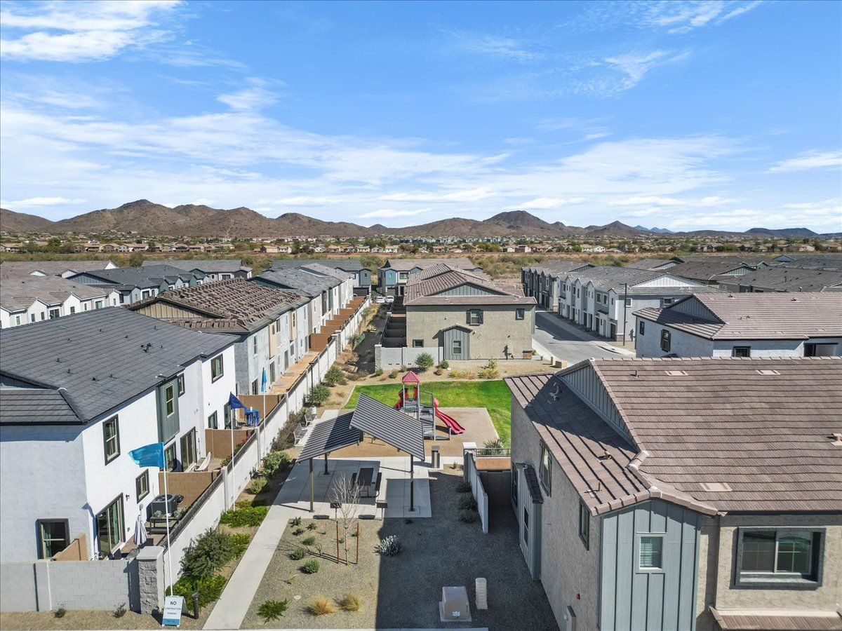 An aerial view of a residential neighborhood with mountains in the background.