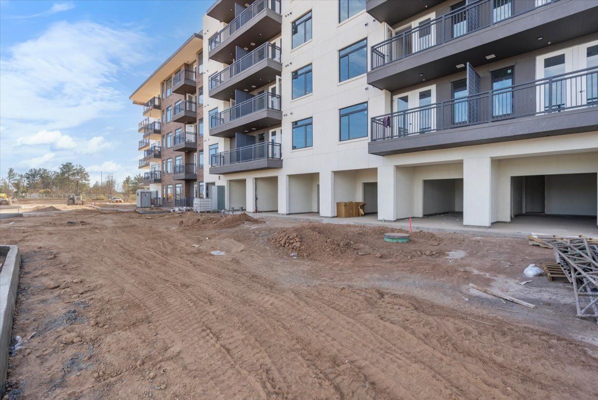 A building under construction with a lot of dirt in front of it.
