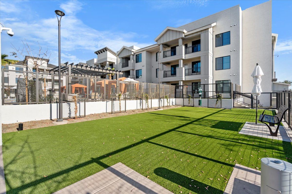 There is a dog park in front of a building.