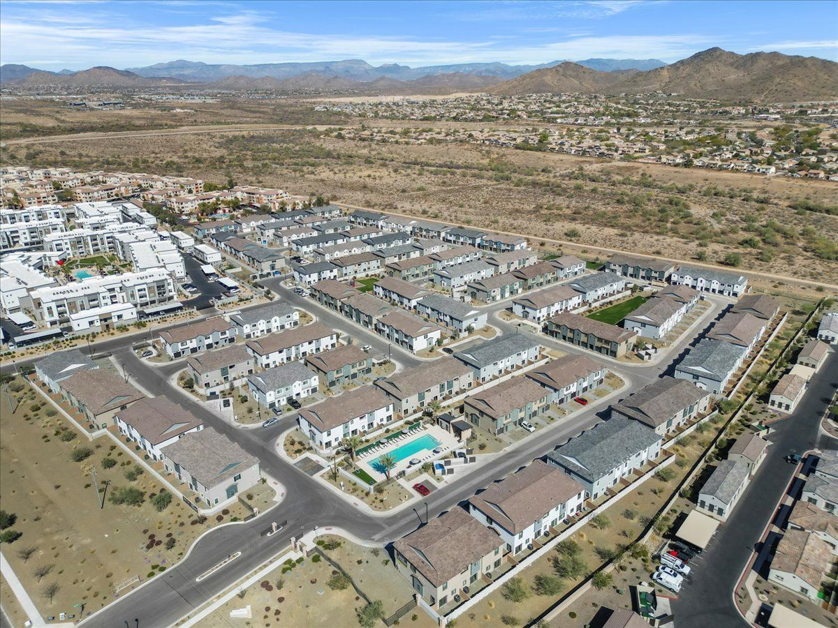 An aerial view of a residential area with mountains in the background.