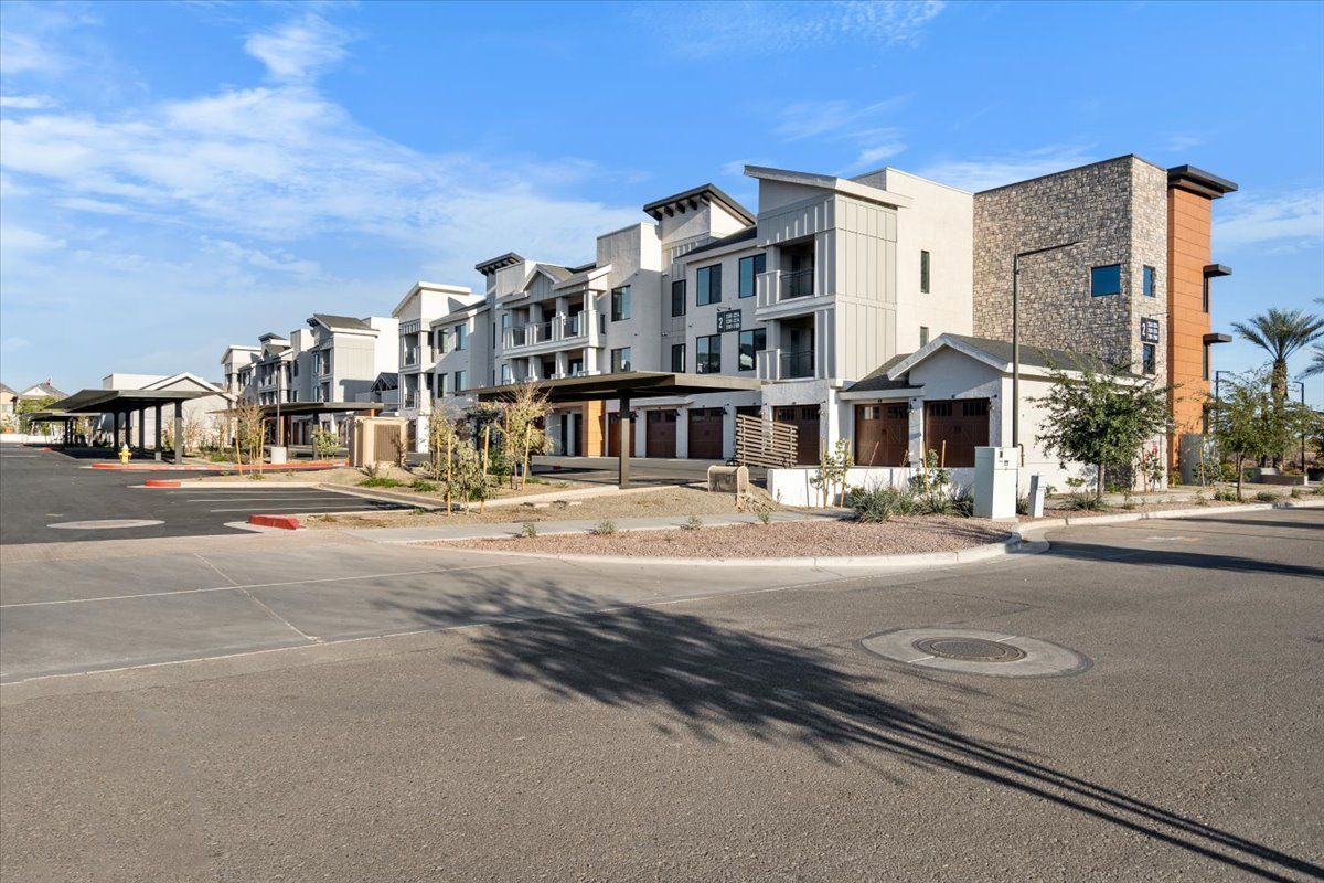 A row of apartment buildings sitting next to each other on the side of a road.
