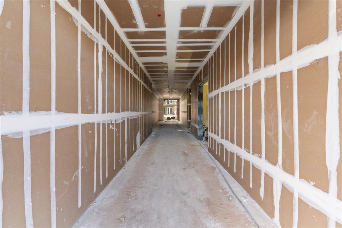 A long hallway with brown walls and white stripes on the ceiling.