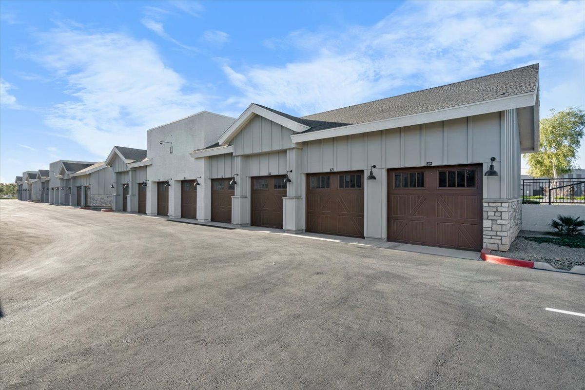 A row of garage doors are lined up in front of a building.