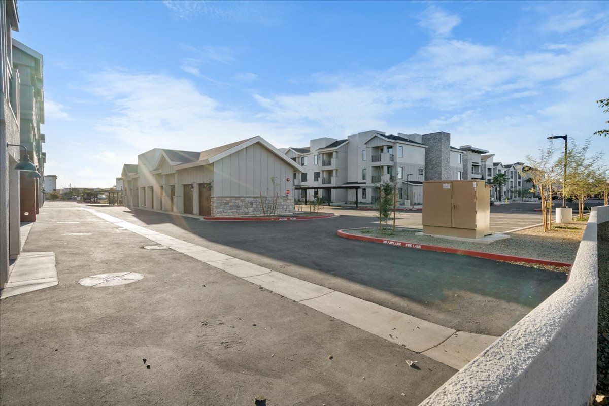 A parking lot with a lot of buildings in the background.