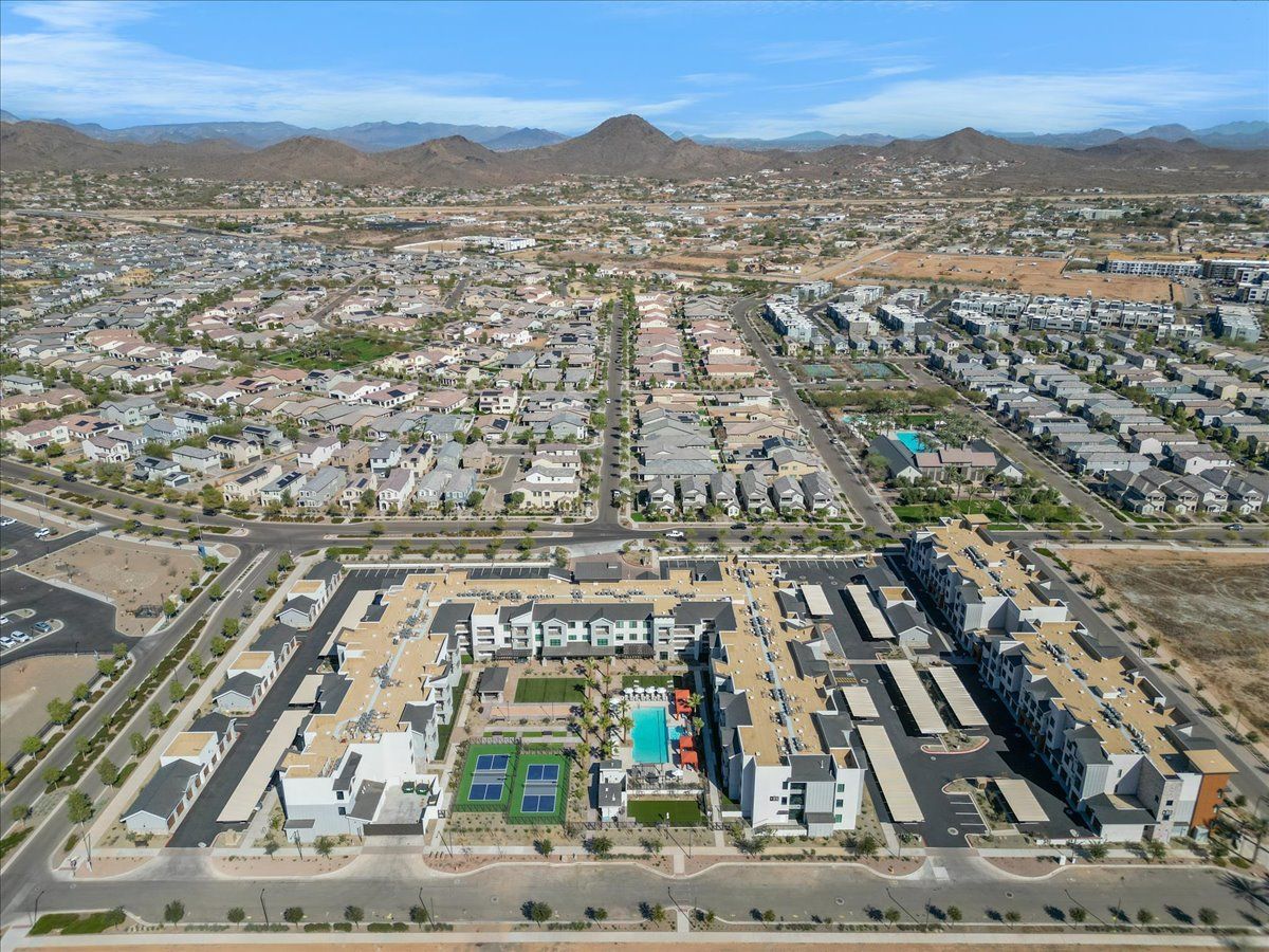 An aerial view of a city with mountains in the background.