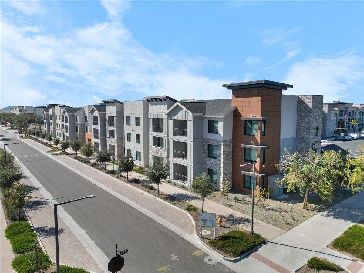 An aerial view of a row of apartment buildings along a street.