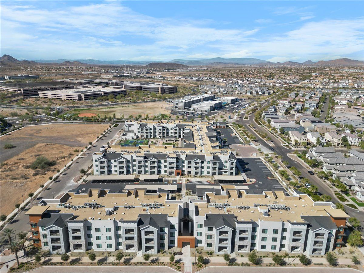 An aerial view of a residential area with lots of buildings and trees.