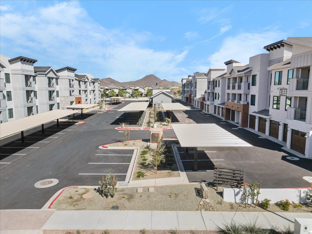 An aerial view of a parking lot surrounded by apartment buildings.