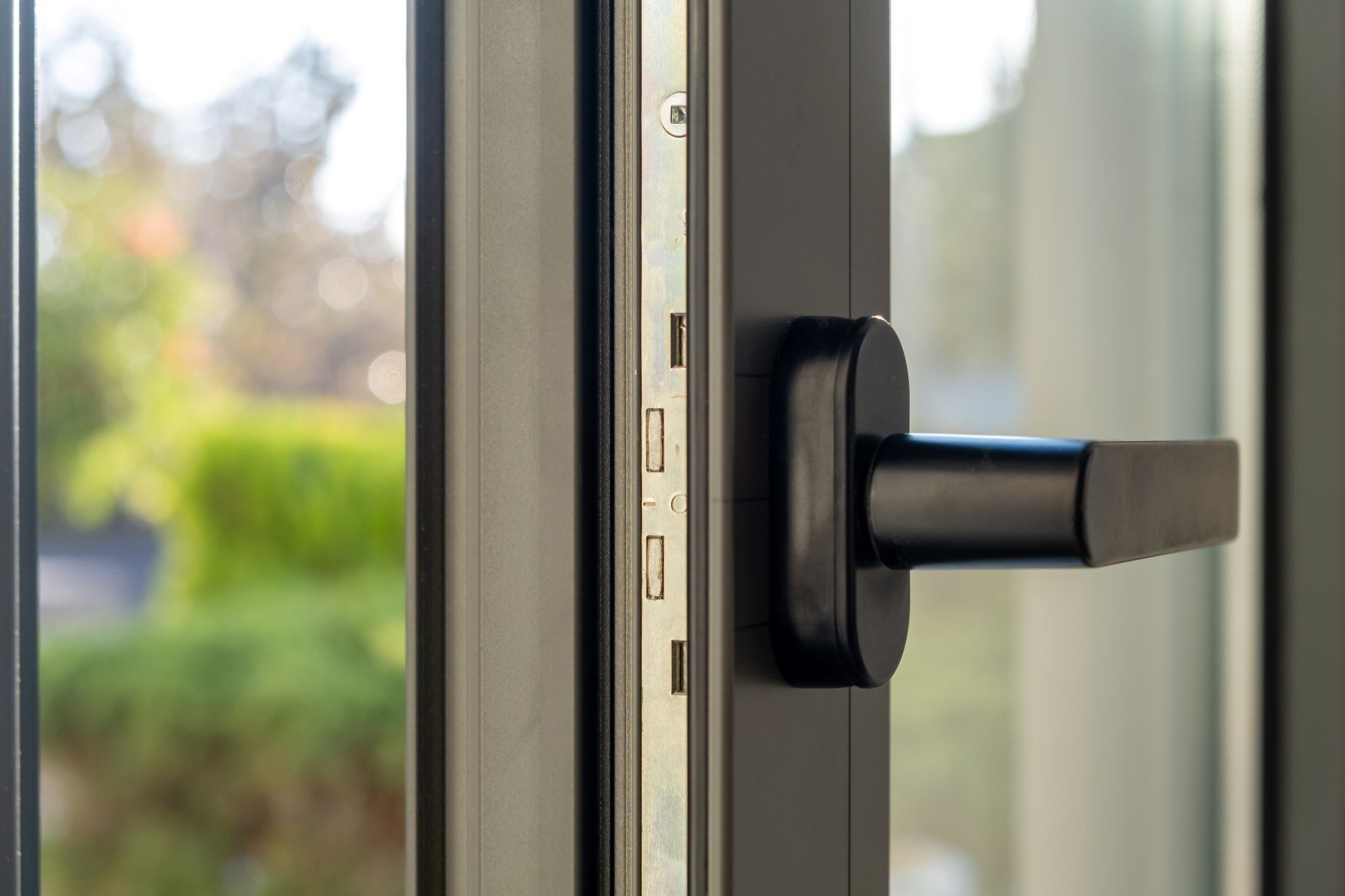 A Close Up Of A Window With A Black Handle — Affordable Blinds, Doors & Security Pty Ltd in Tweed Heads South, NSW