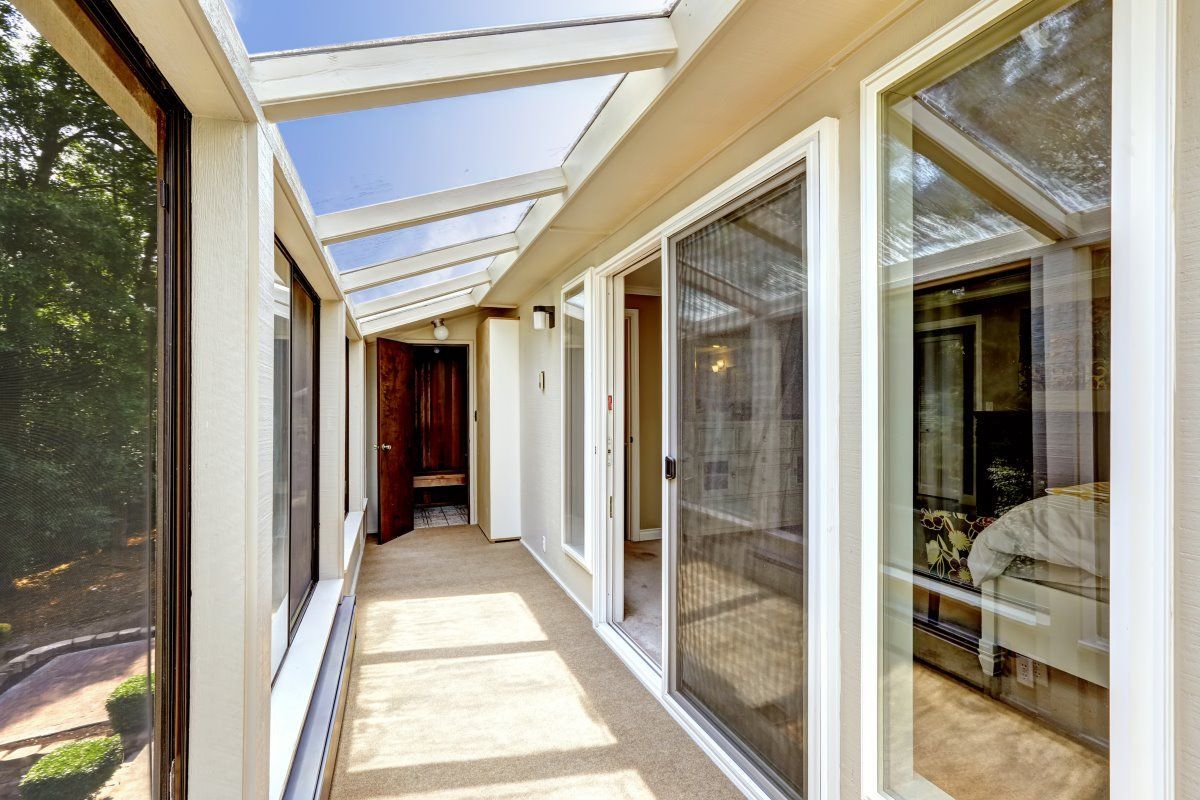 A Long Hallway With Lots Of Windows And A Glass Roof — Affordable Blinds, Doors & Security Pty Ltd in Tweed Heads South, NSW