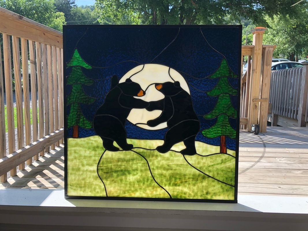 Stained glass art of two black bears