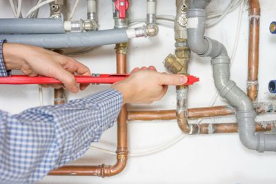 Plumbing Services — Hand of A Man Handling Plumbing Tools Fix the Pipe in Plainfield, IN