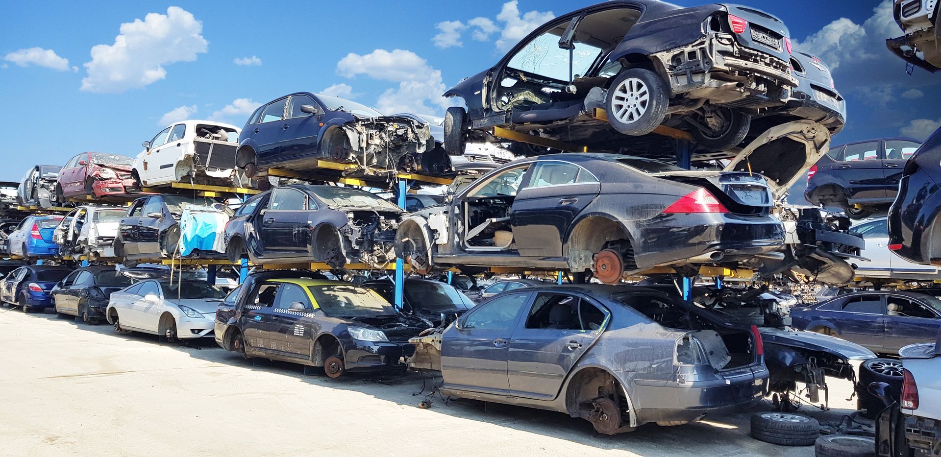 Wrecked vehicles on the junkyard.