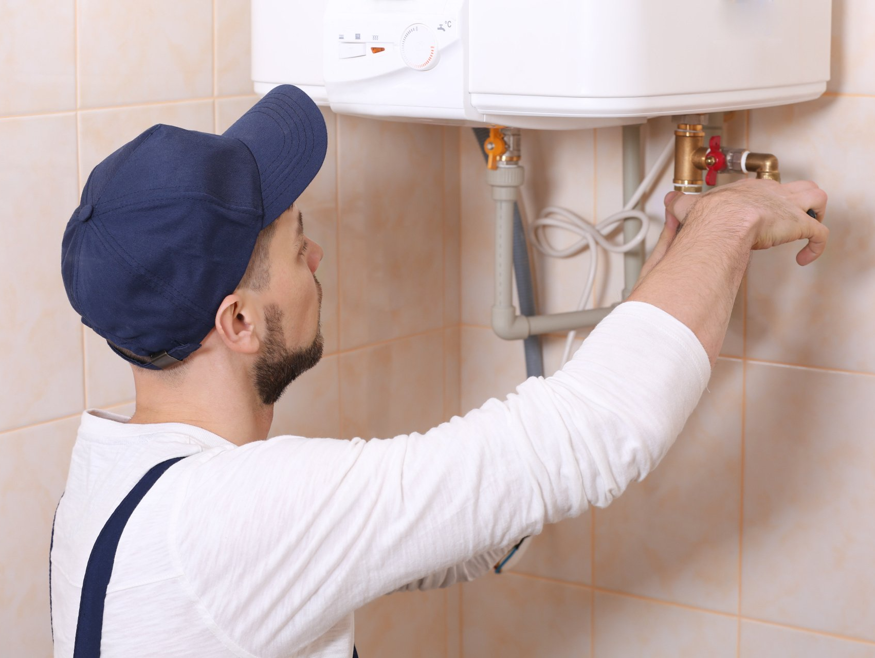 a professional conducting hot water heater repairs