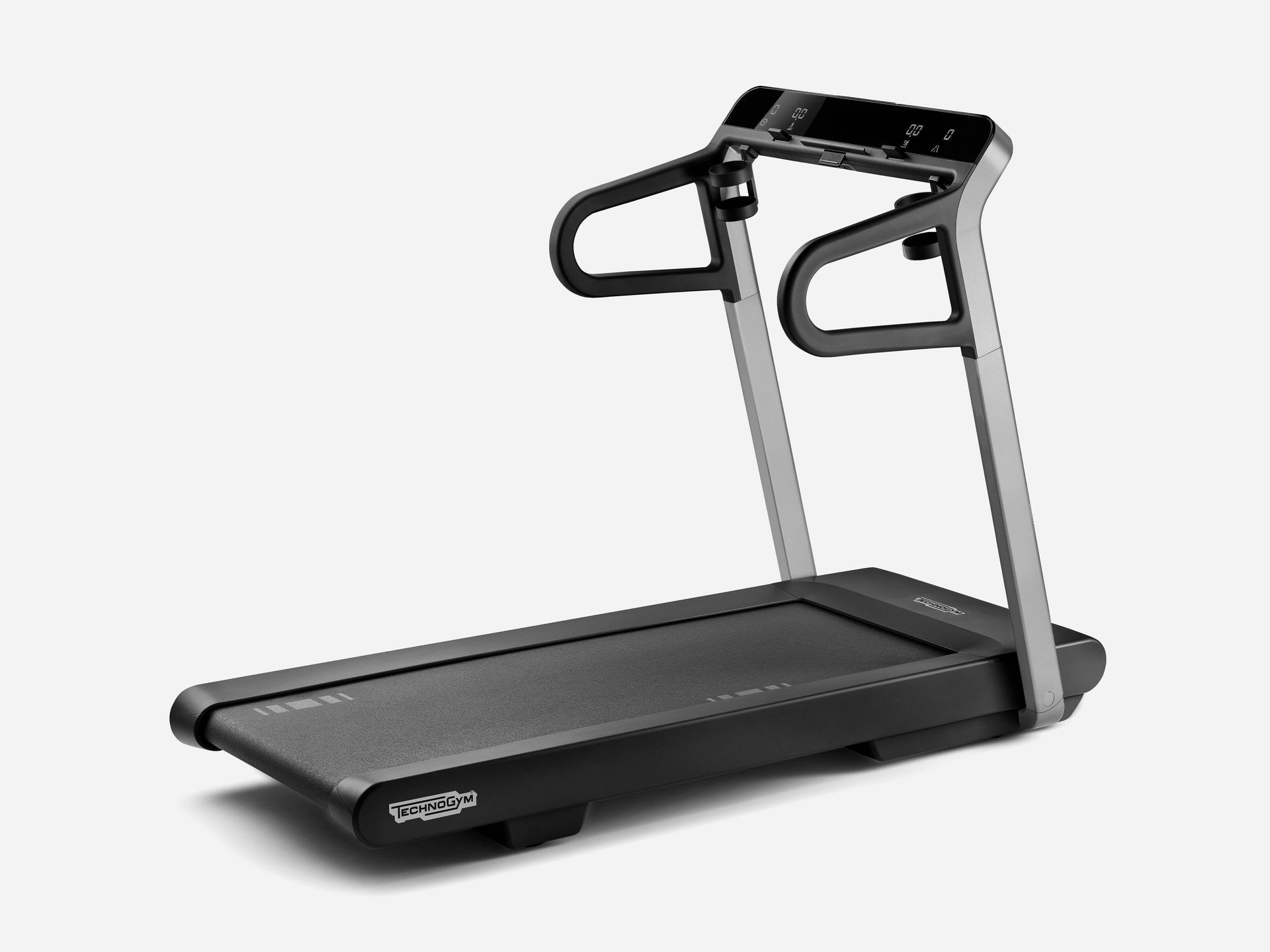 A black Technogym treadmill with metallic uprights on a light gray background.