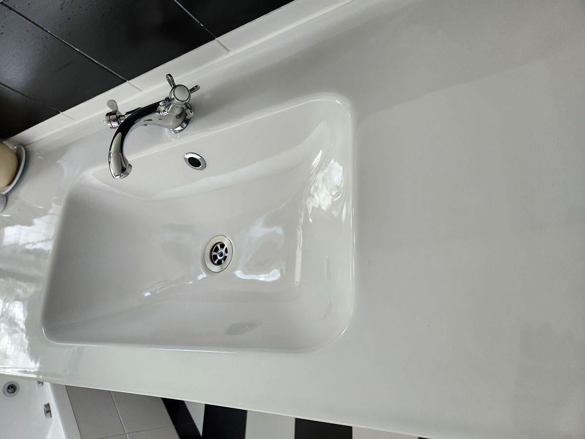 White Rectangular Bathroom Sink with A Chrome Faucet, Set on A White Counter — KirraLina Cleaning Services in Tweed Heads, NSW