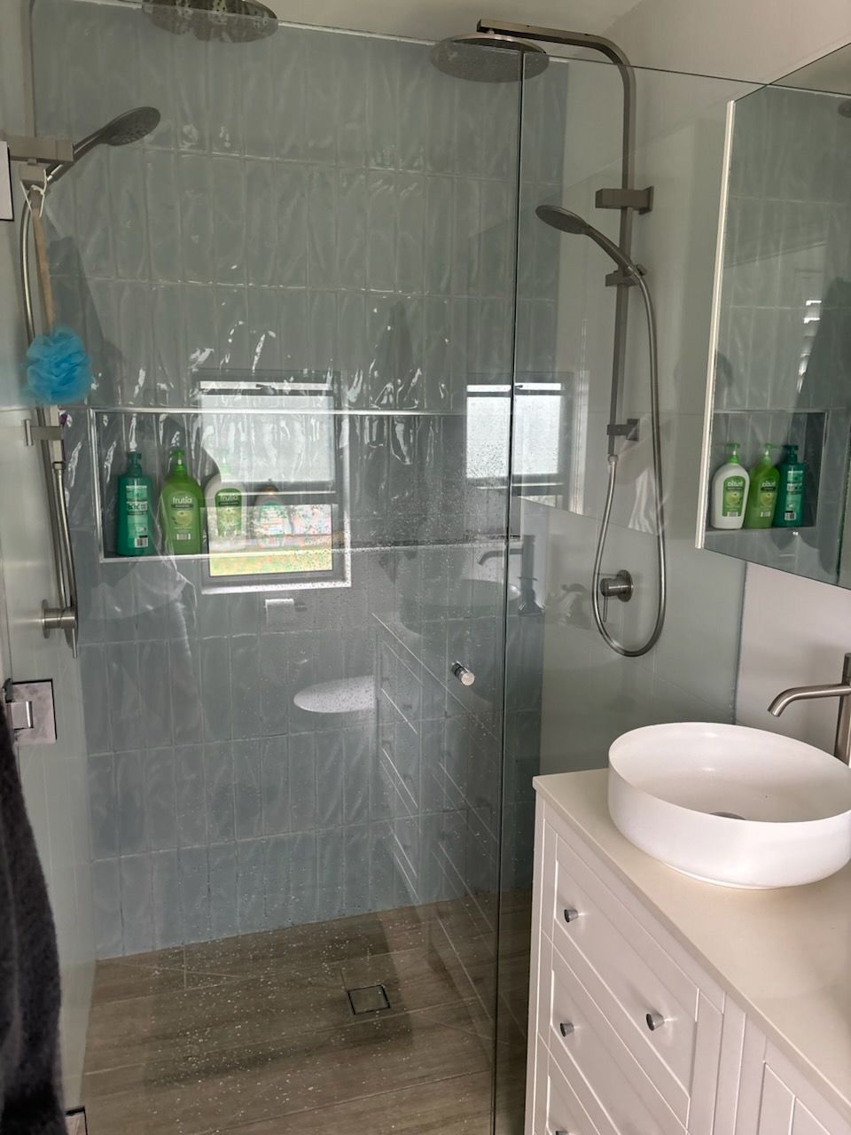 Bathroom with Glass Shower, White Sink, and Light Blue Tile — KirraLina Cleaning Services in Tweed Heads, NSW