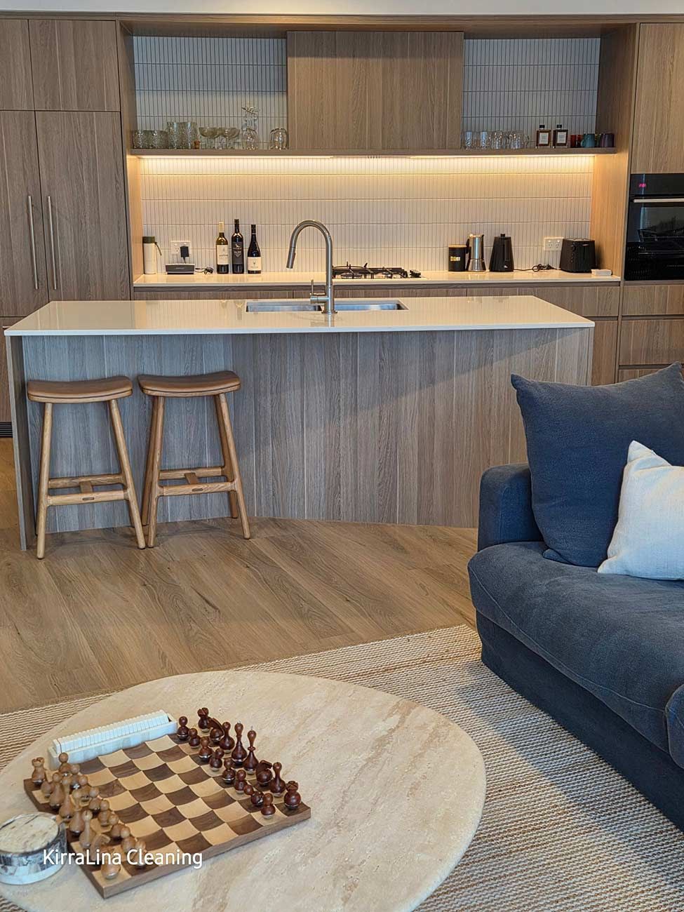 Modern Kitchen with Wooden Cabinets and Island — KirraLina Cleaning Services in Tweed Heads, NSW