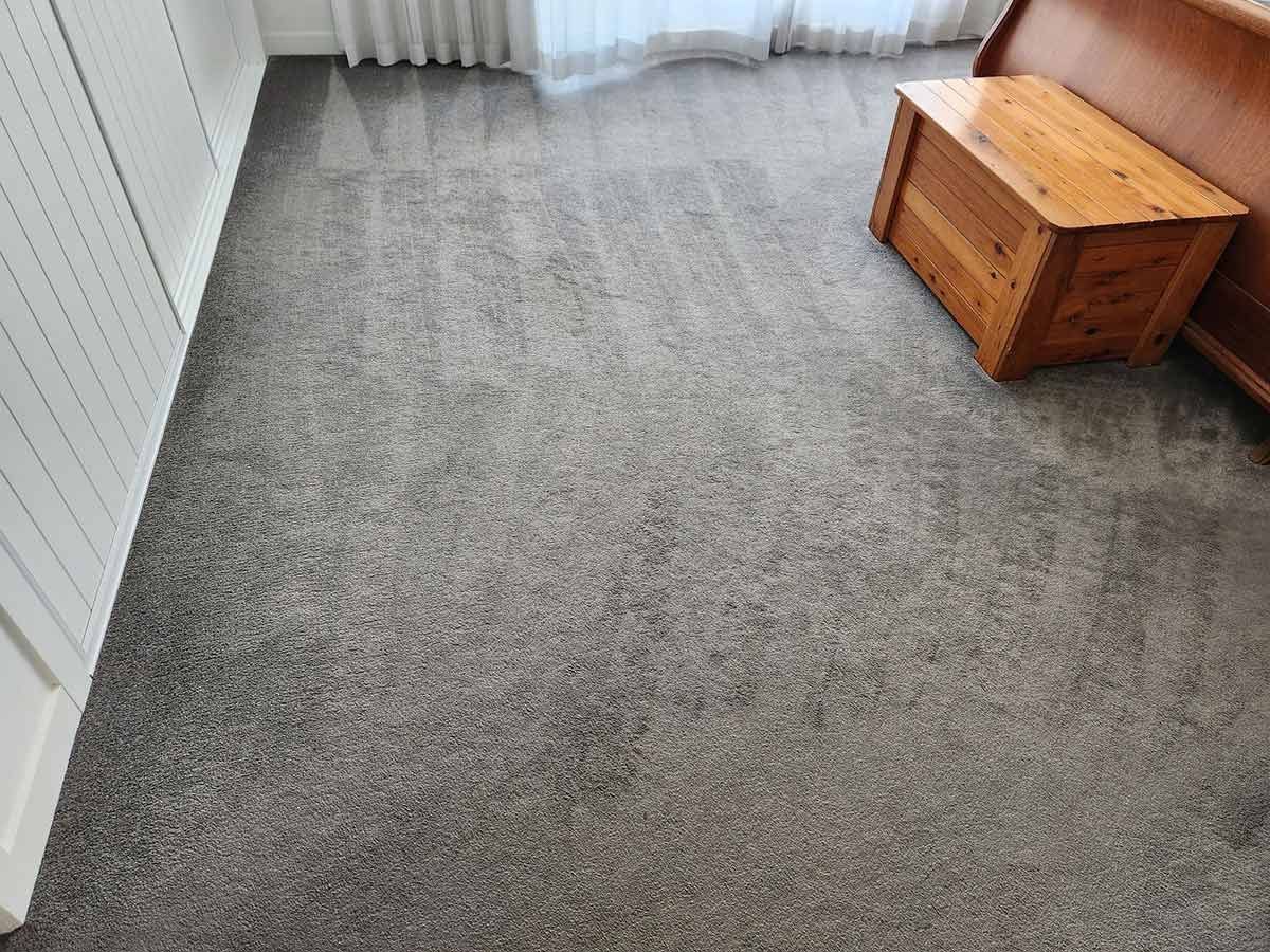 A Room with Gray Carpet, a Wooden Chest, and White Trim — KirraLina Cleaning Services in Tweed Heads, NSW