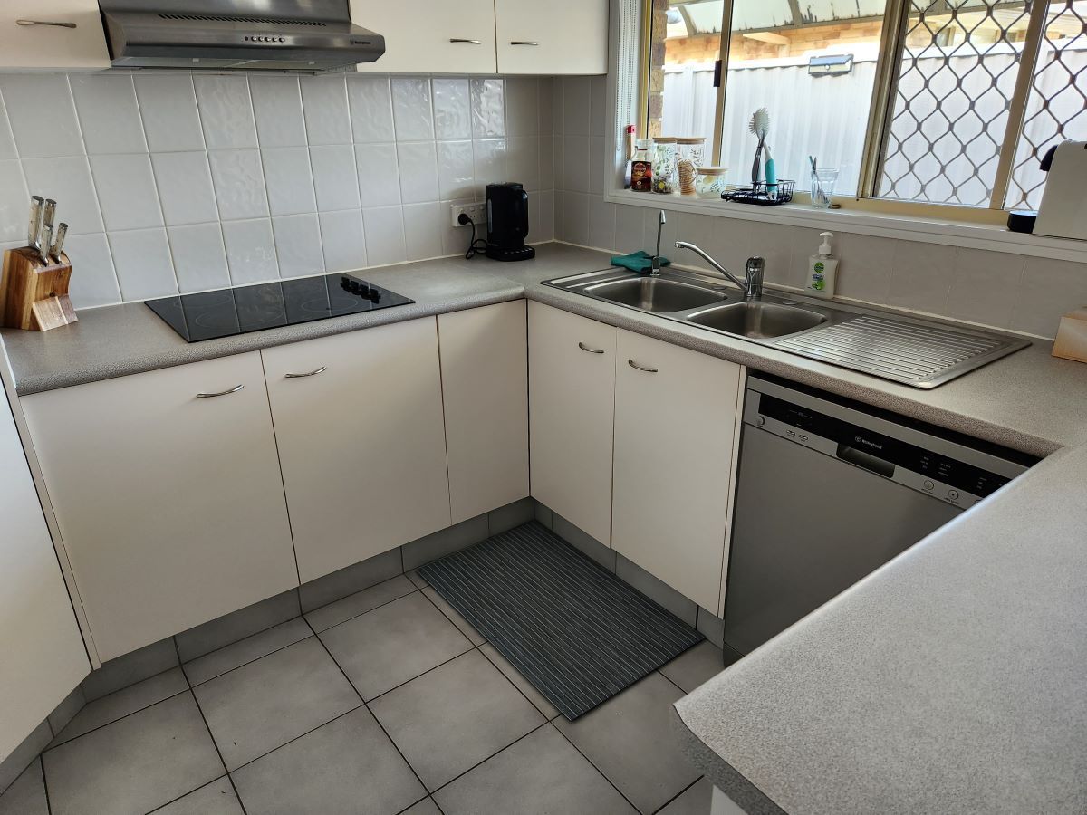 A Kitchen with Cabinets and A Stove Top Oven — KirraLina Cleaning Services in Palm Beach, NSW