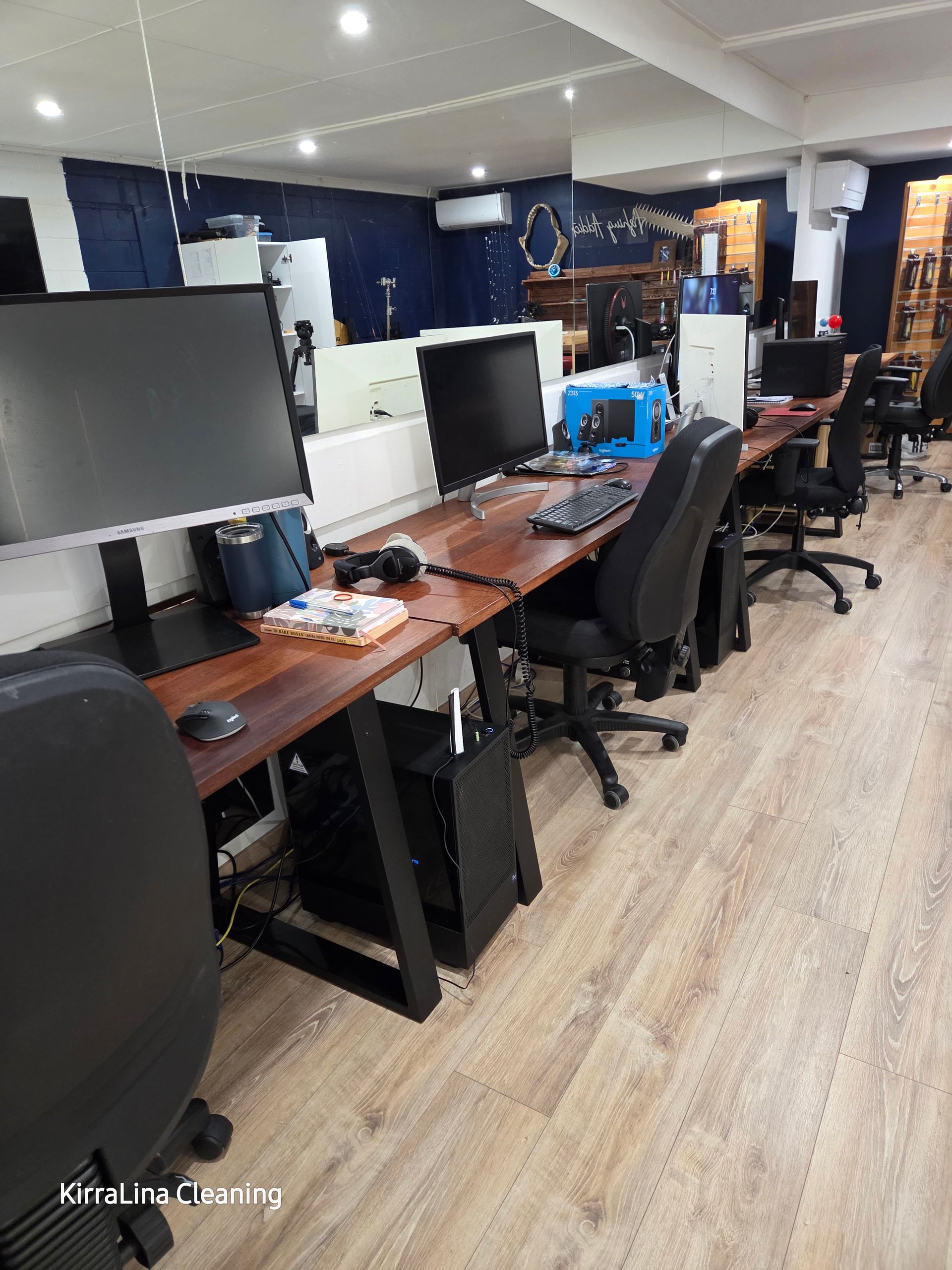 Multiple black computer screens set up in an office — KirraLina Cleaning Services in Burleigh Heads, QLD