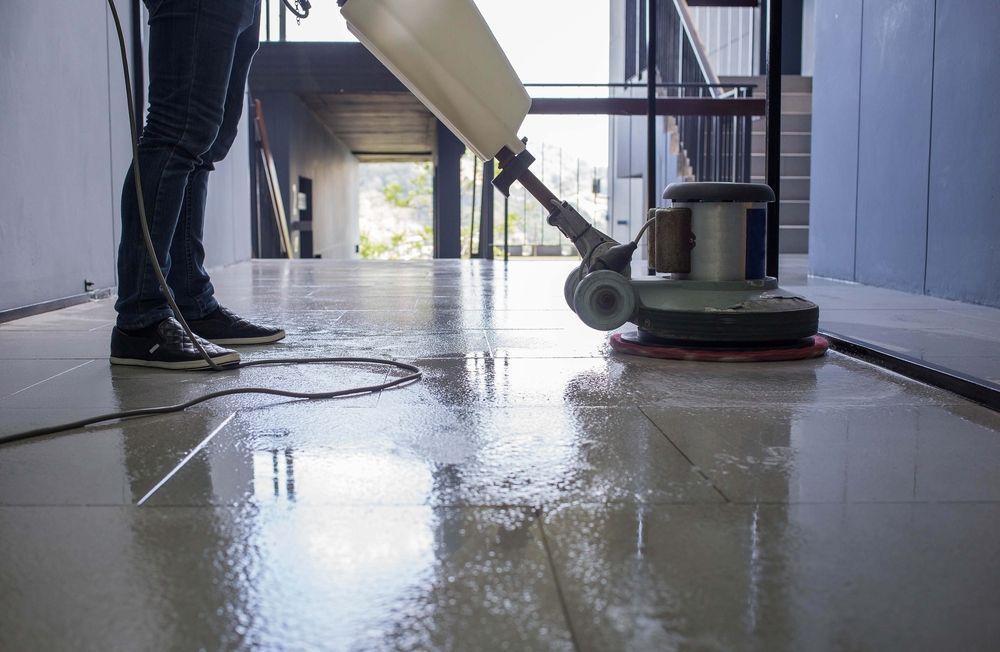 Person Using a Floor Buffer on a Shiny Indoor Floor in a Hallway — KirraLina Cleaning Services in Tweed Heads, NSW