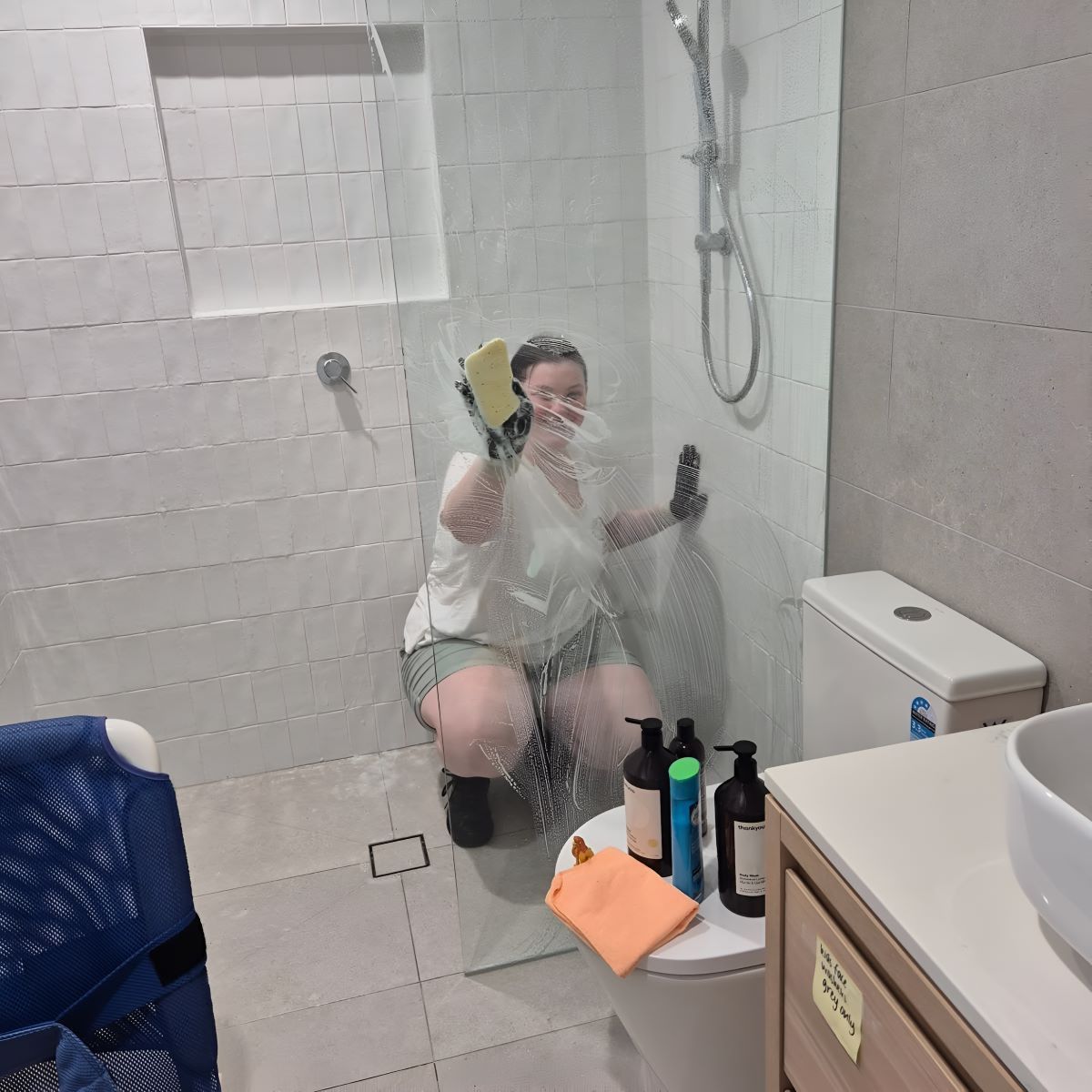 A Woman Is Cleaning a Bathroom — KirraLina Cleaning Services in Tweed Heads, NSW