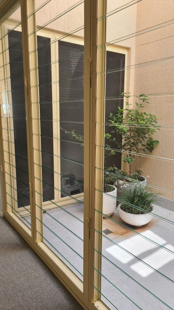 A Room with Windows and Potted Plants — KirraLina Cleaning Services in Palm Beach, NSW