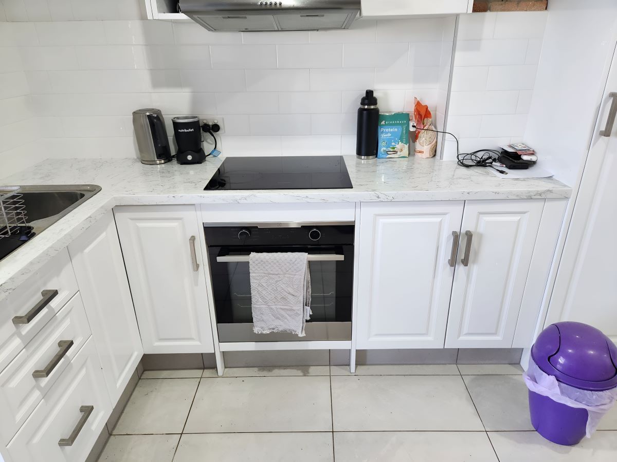 A Kitchen with Cabinets and A Trash Can — KirraLina Cleaning Services in Casuarina, NSW