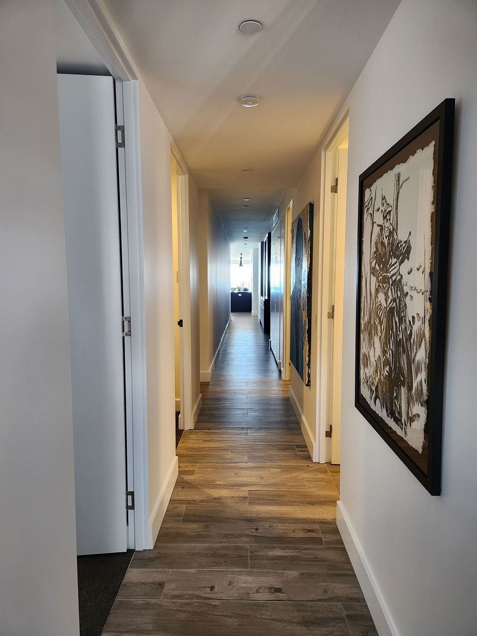 Long, Narrow Hallway with Wood-Look Tile Flooring and White Walls — KirraLina Cleaning Services in Tweed Heads, NSW