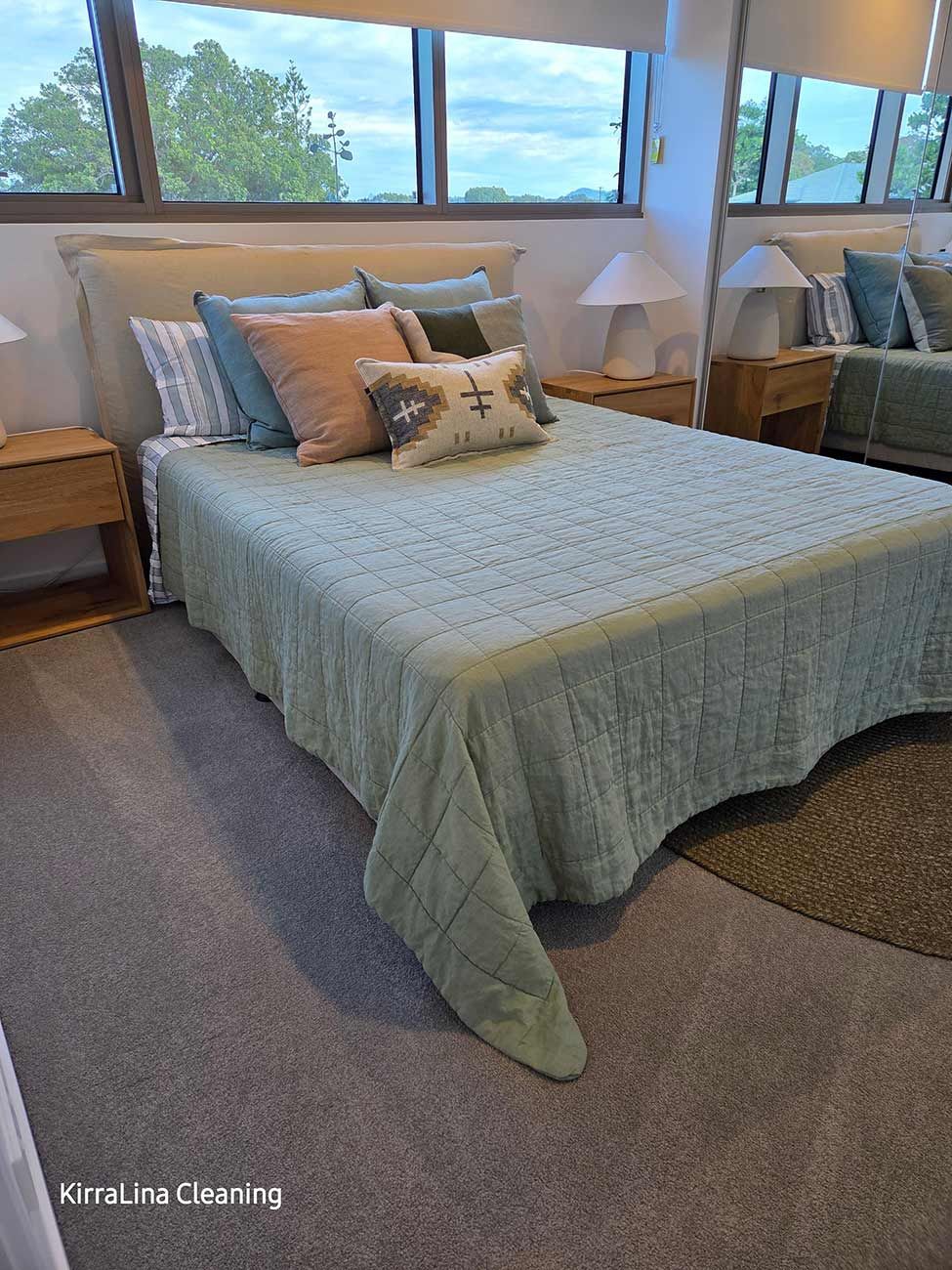 Bedroom with A Light Blue Bedspread, Pillows in Shades of Blue — KirraLina Cleaning Services in Tweed Heads, NSW