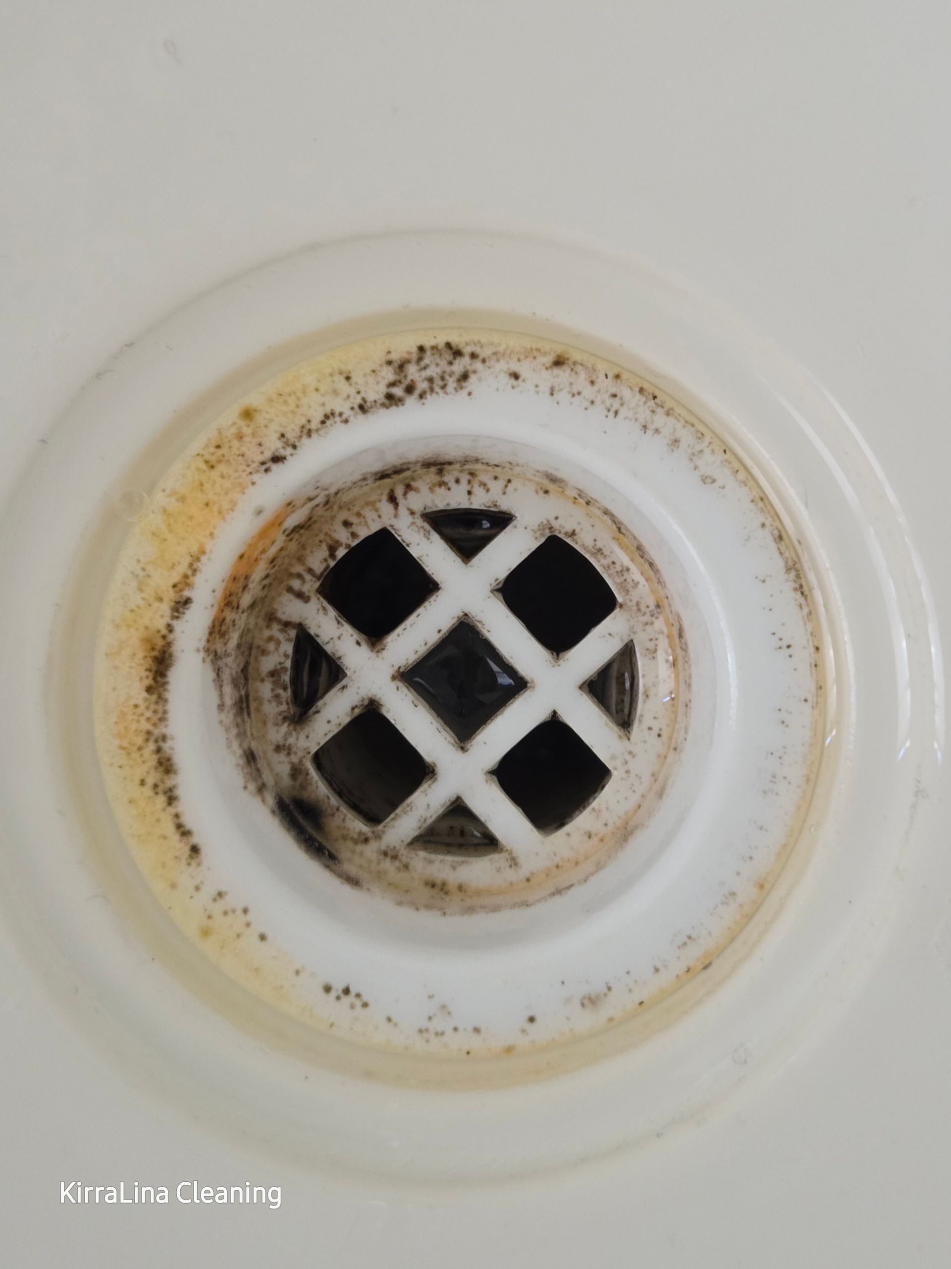 Before: Close-up of a Dirty Bathtub Drain With a White Ring and Black and Yellow Grime — KirraLina Cleaning Services in Kingscliff, NSW