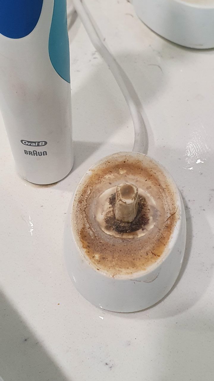 A Close Up of a Dirty Electric Toothbrush Holder on a Counter — KirraLina Cleaning Services in Tweed Heads, NSW