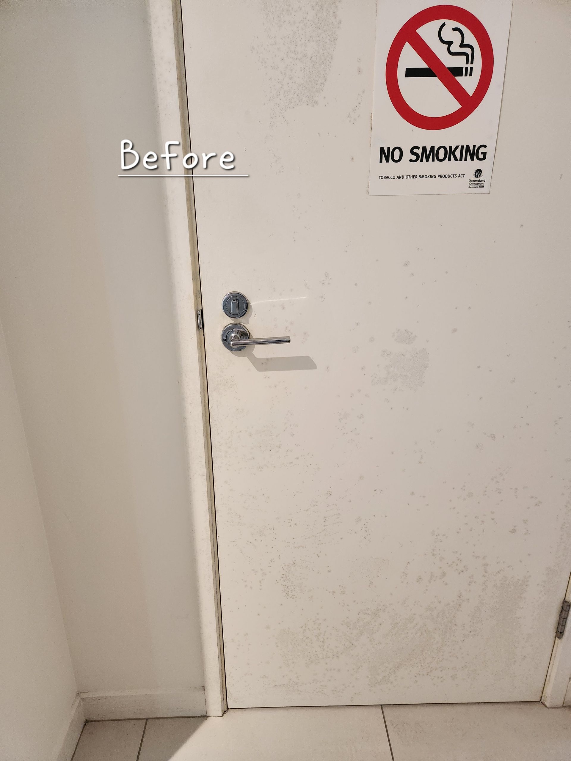 Before: White Door With No Smoking Sign. Door Has Stains and Silver Handle — KirraLina Cleaning Services in Banora Point, NSW