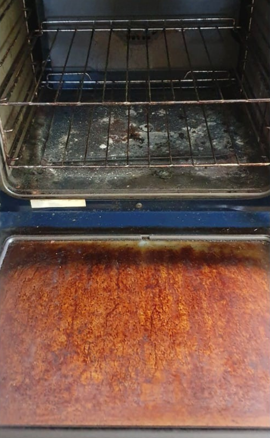 A Dirty Oven With a Tray of Food in It — KirraLina Cleaning Services in Tweed Heads, NSW