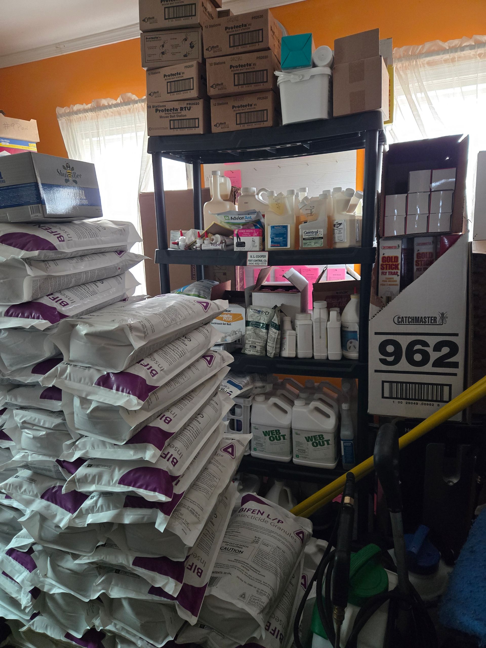 Shelves overflowing with supplies. Stacked bags and boxes, various bottles, and a barcode on a sign.