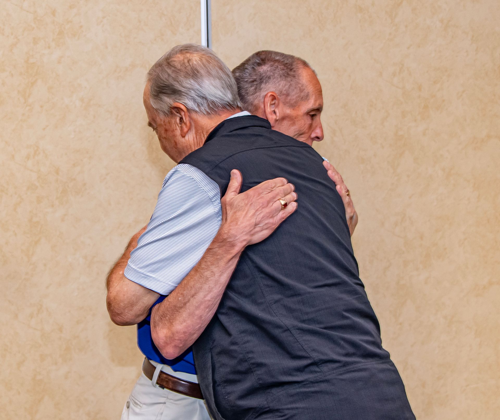 Two men hugging each other at the awards ceremony
